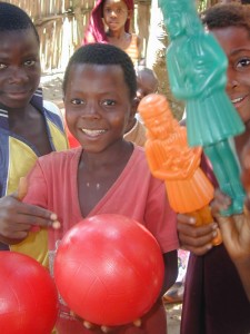Children smiling, their new toys in hand!