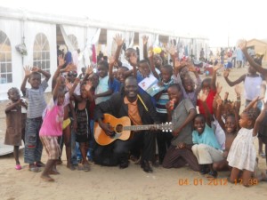 Etienne singing Gospel songs for refugees in Brazzaville
