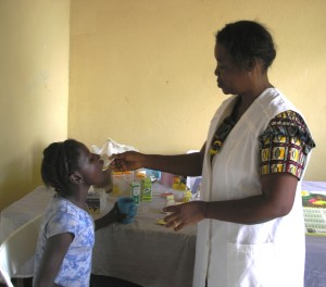 Florence giving vitamins to orphaned girl