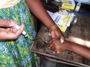 Florence administering an IV Drip to malaria patient