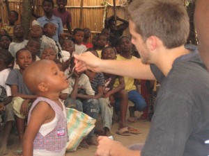 Mike giving vitamins to orphaned child back in 2009