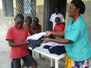 Distributing new school uniforms to orphans