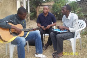 Olivier learning guitar and teaching university students our humanitarian course.