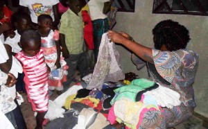 Florence distributing clothes to the children