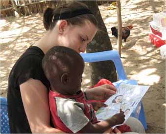 Coloring with young orphaned boy in Kikimi