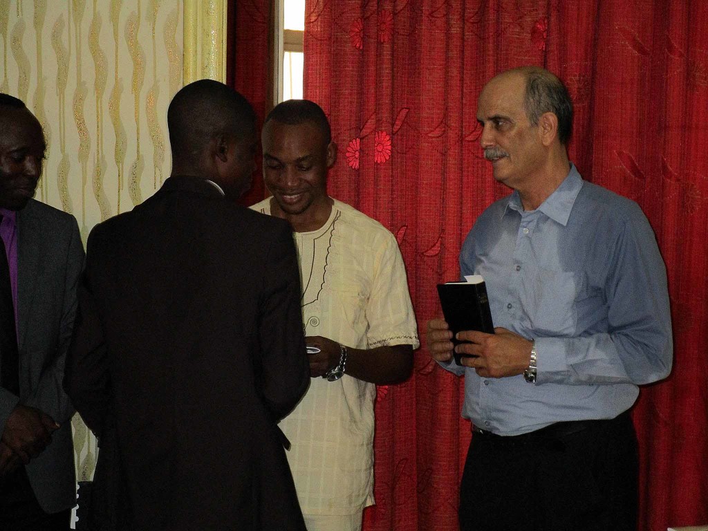 Olivier and Gino giving laureate a CD and other documentation, including a Bible