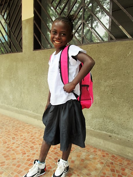 Orphan girl Fatu with new uniform, school bag and shoes.