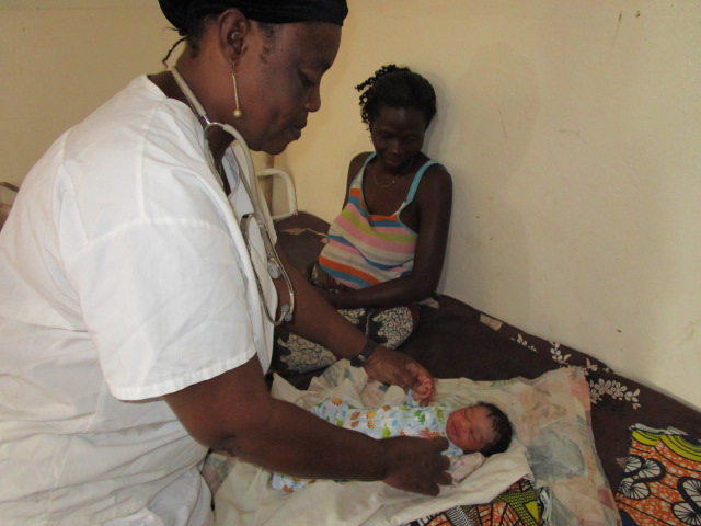 Florence giving newborn baby medical checkup,
