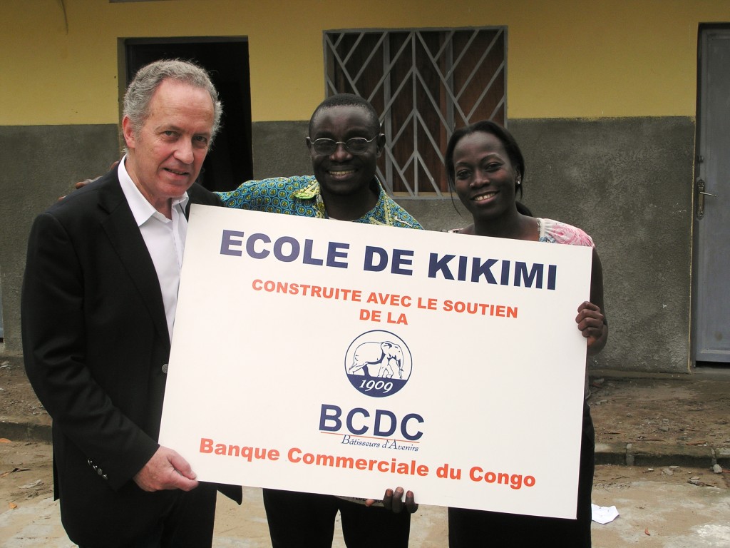 Patricia giving Theo the plaque for the newly built Primary School (with BCDC representative on the left)