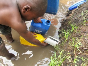 child collecting water from unreliable spring