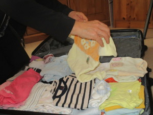 Packing our suitcases with baby clothes