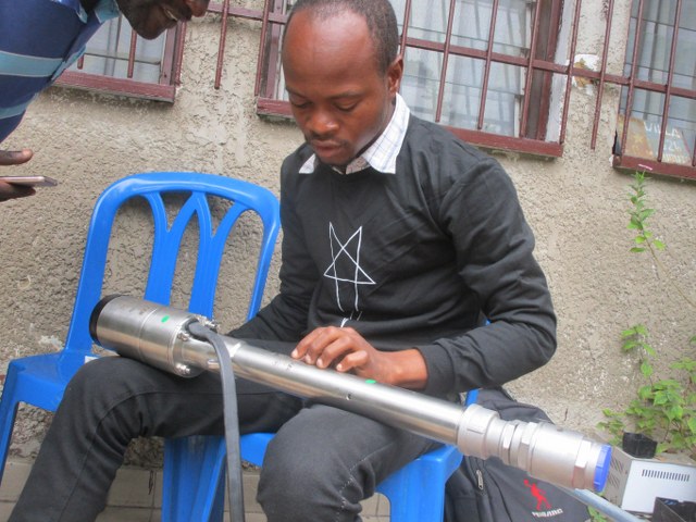 Engineer preparing imported solar pump kit for installation.