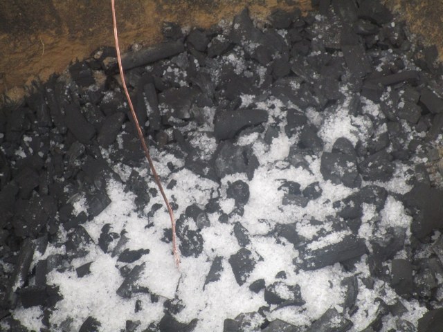 Installing earth stake with charcoal and salt