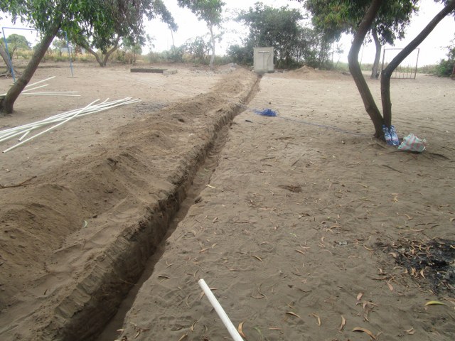 Digging trenches to install water pipes.