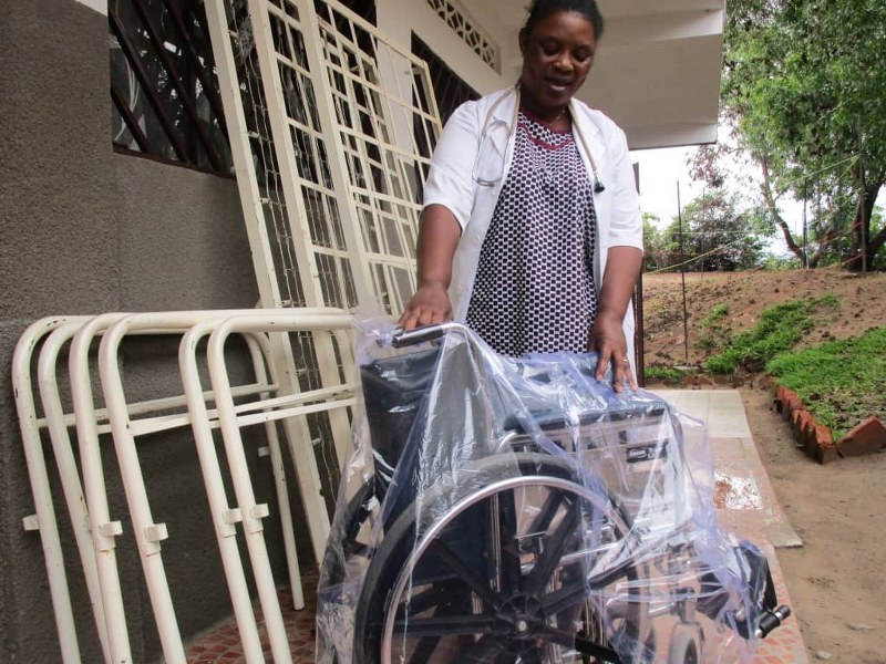Florence with 3 new hospital beds and a wheel chair for needy patients.